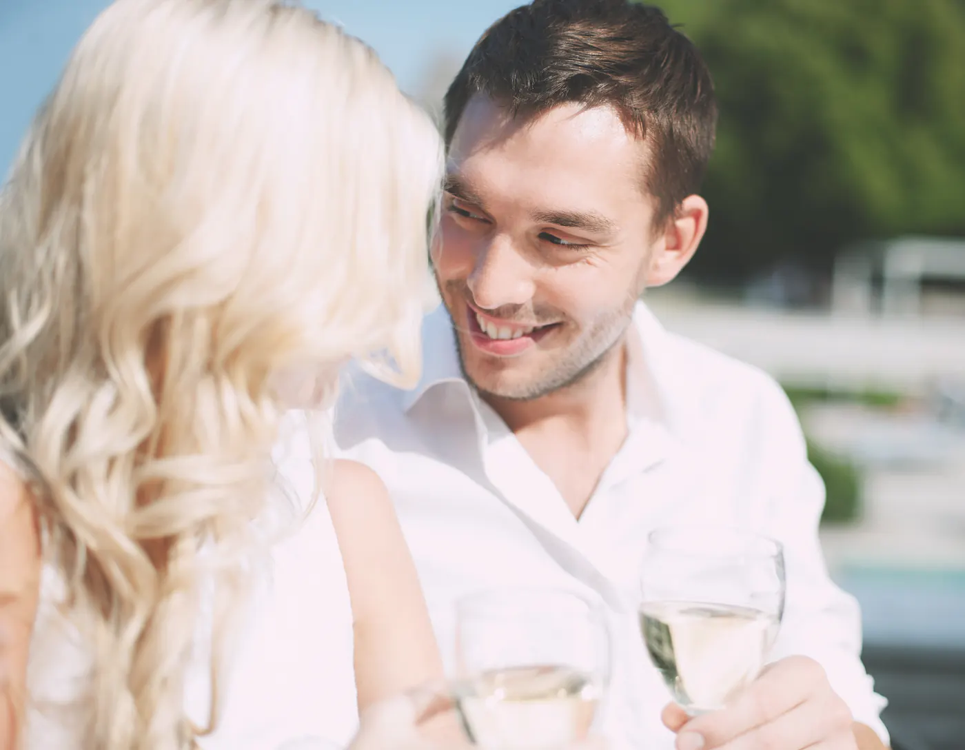 A couple sharing wine at an outdoor café